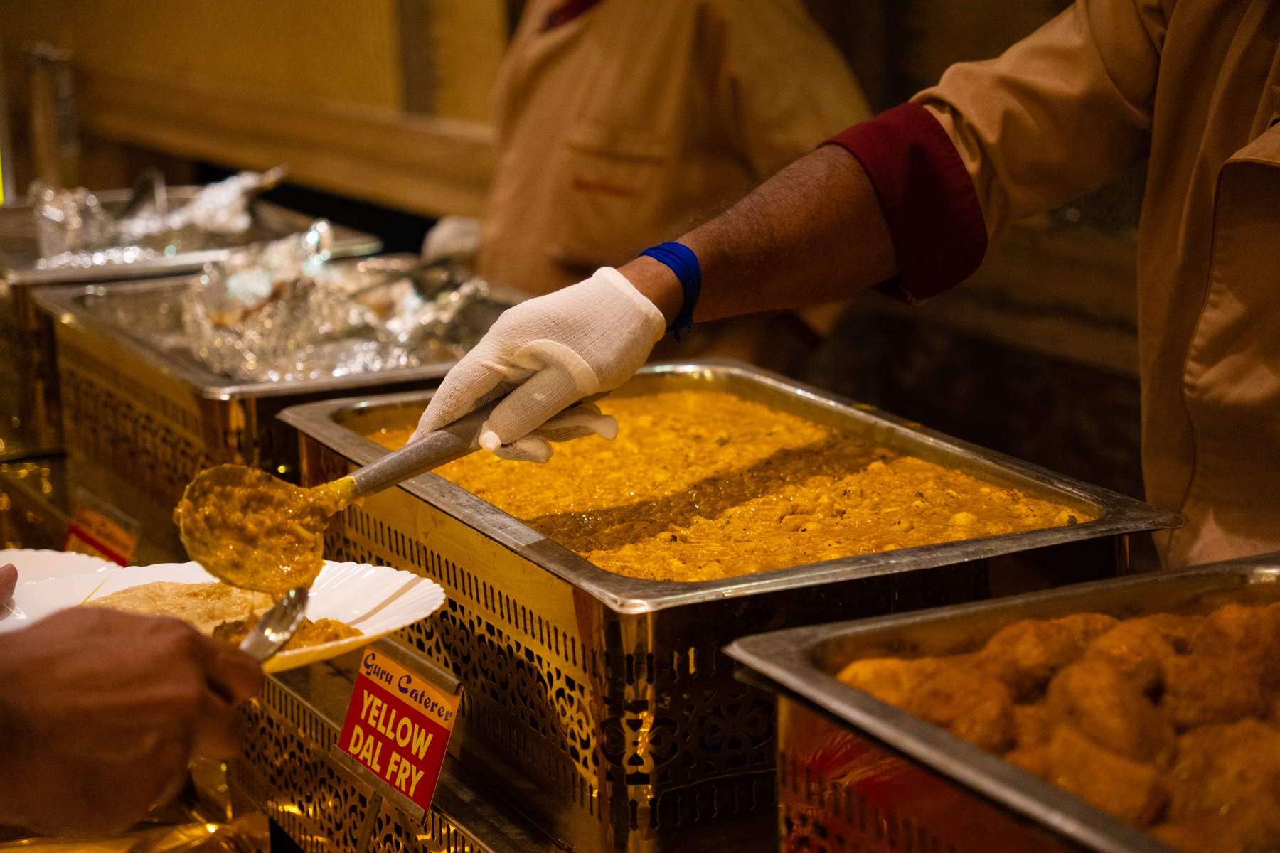 Guru Caterer team plating a dish